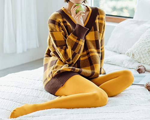 woman with mustard color elastic tights sitting on white bad.